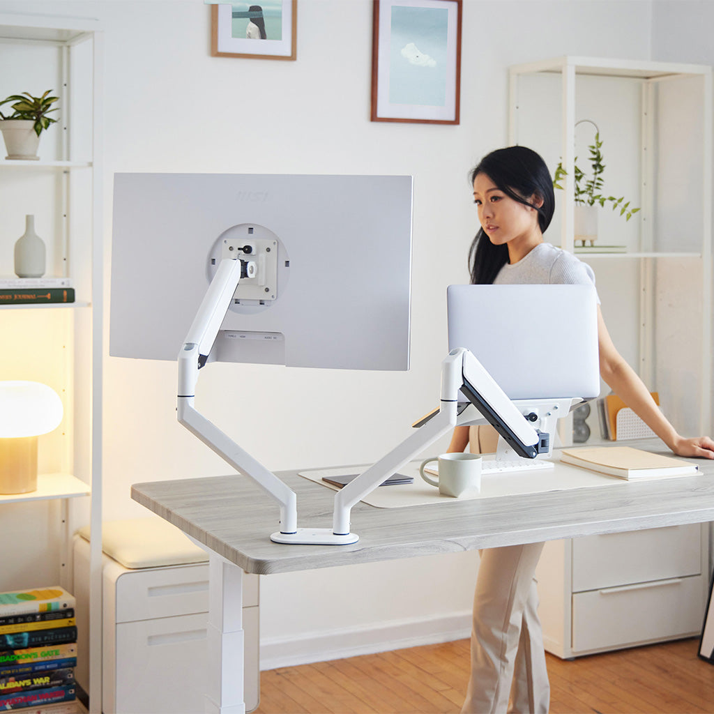 https://risedesk.io/cdn/shop/products/dual-white-monitor-arm-with-laptop-tray-editorial.jpg?v=1707837184&width=1024